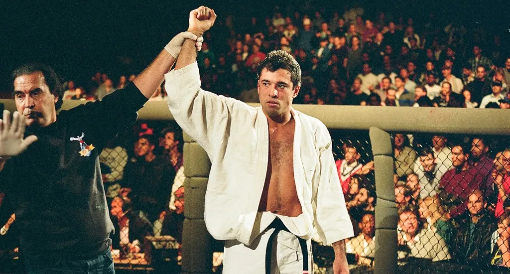 Royce Gracie with his arm raised in victory at an early UFC event